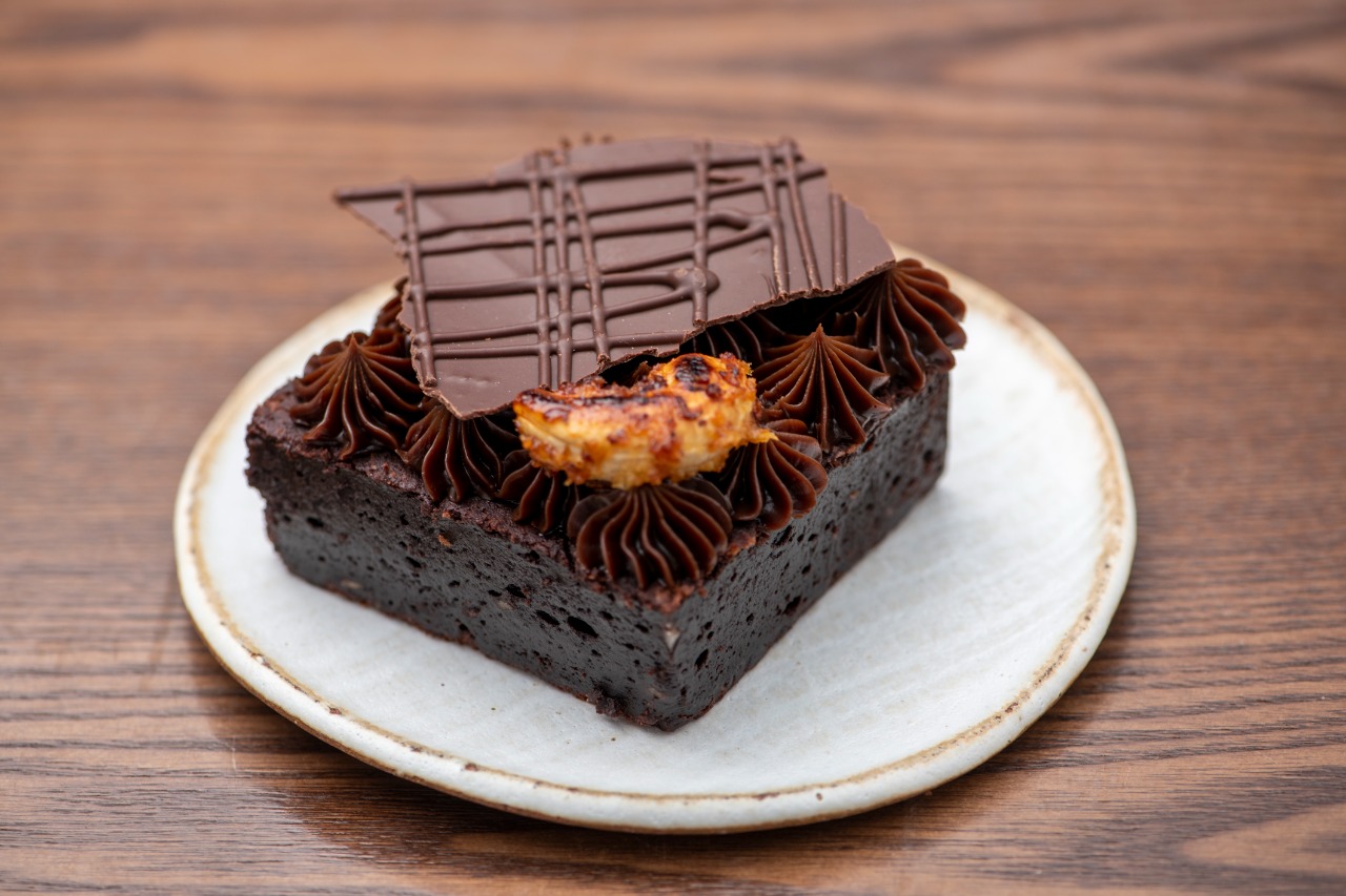 Chocolate: brownie confeitado em um prato branco de sobremesa