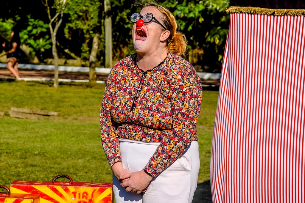 Circo: mulher vestida de palhaça encenando uma cena